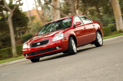 Kia Optima making a hard turn in a suburban neighborhood