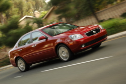 Kia Optima racing uphill in a suburban neighborhood